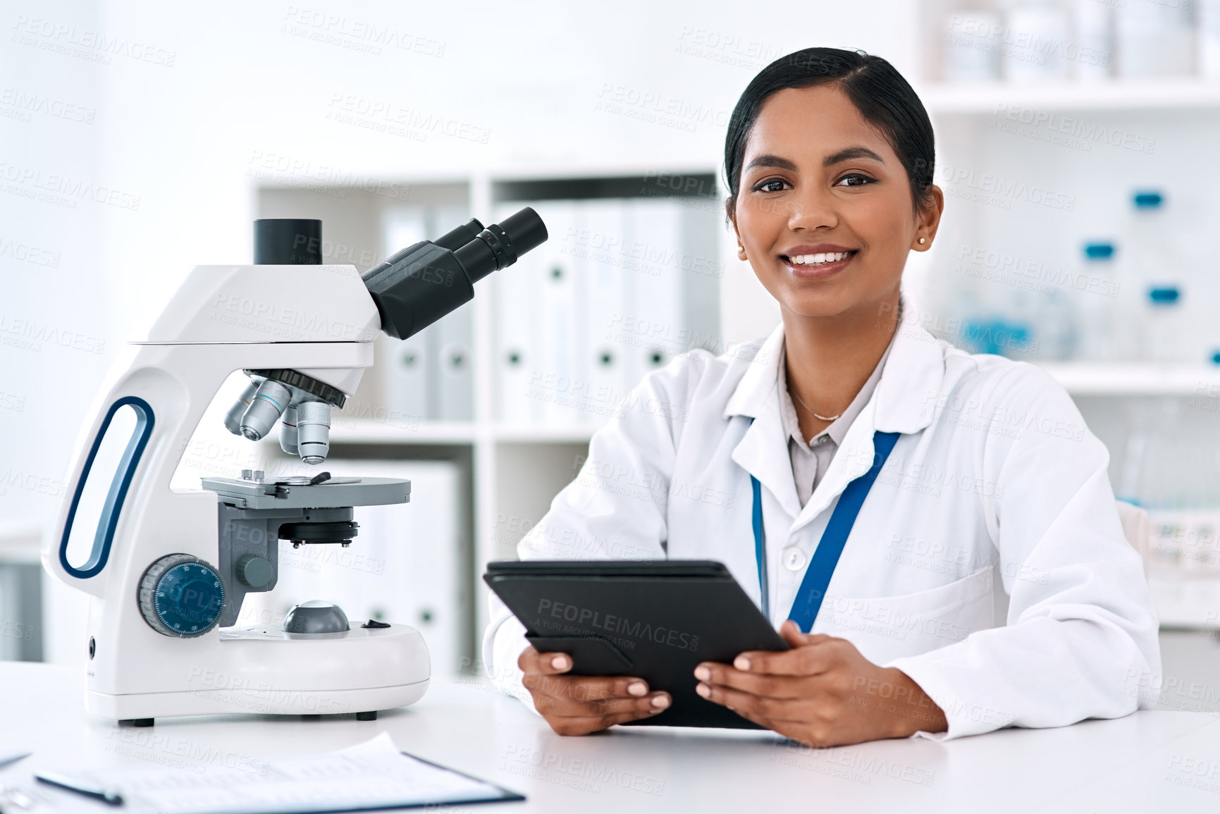 Buy stock photo Portrait, tablet and woman in lab for science, research and microscope for biotechnology. Female scientist, smile and technology at table for communication, update and consultation or telehealth