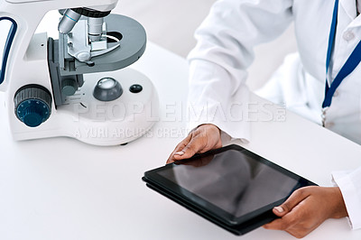 Buy stock photo High angle shot of an unrecognizable female scientist using a digital tablet while working in a laboratory
