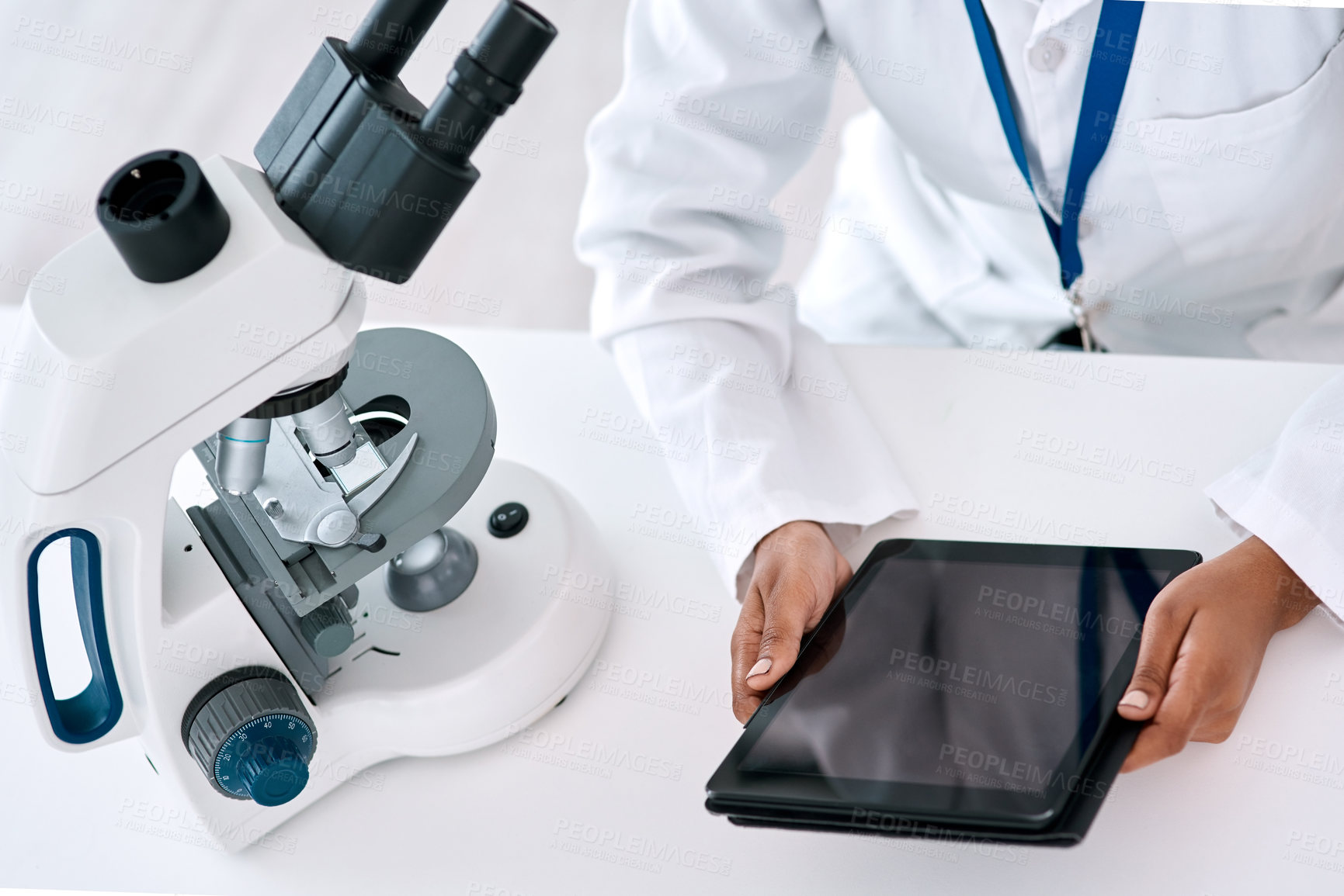 Buy stock photo High angle shot of an unrecognizable female scientist using a digital tablet while working in a laboratory
