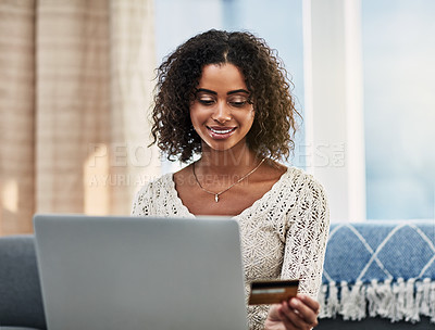 Buy stock photo Shot of an attractive young woman making payments online with a credit card