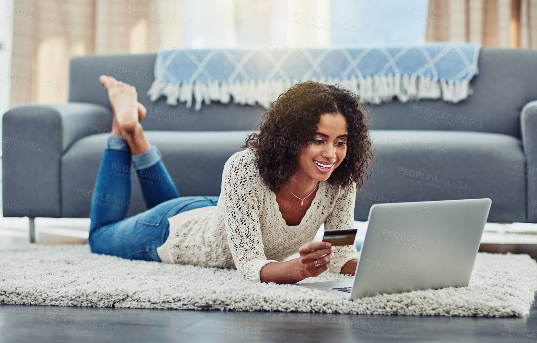 Buy stock photo Shot of an attractive young woman making payments online with a credit card