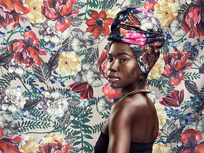 Buy stock photo Studio shot of a beautiful young woman wearing a traditional African head wrap against a floral background