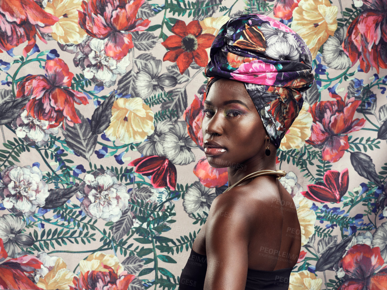 Buy stock photo Studio shot of a beautiful young woman wearing a traditional African head wrap against a floral background