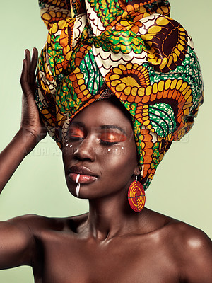 Buy stock photo Culture, beauty and black woman in head wrap in studio with cultural, glow and cosmetics on green background. Face, makeup and African female model with turban, tradition and confidence isolated