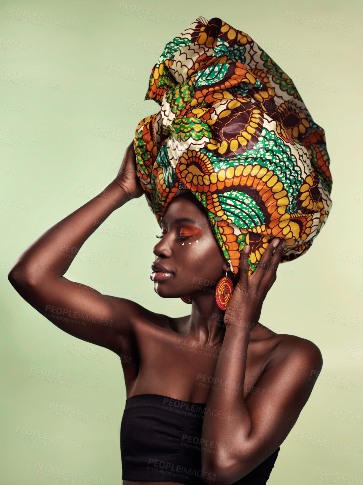 Buy stock photo Culture, fashion and black woman in head wrap in studio for makeup, glow and cosmetics on green background. Face, beauty and african female model with pride, tradition and confidence isolated