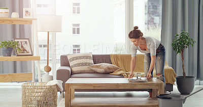 Buy stock photo Shot of a young woman cleaning her living room