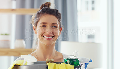 Buy stock photo Closeup shot of a young woman holding a bucket with cleaning supplies at home
