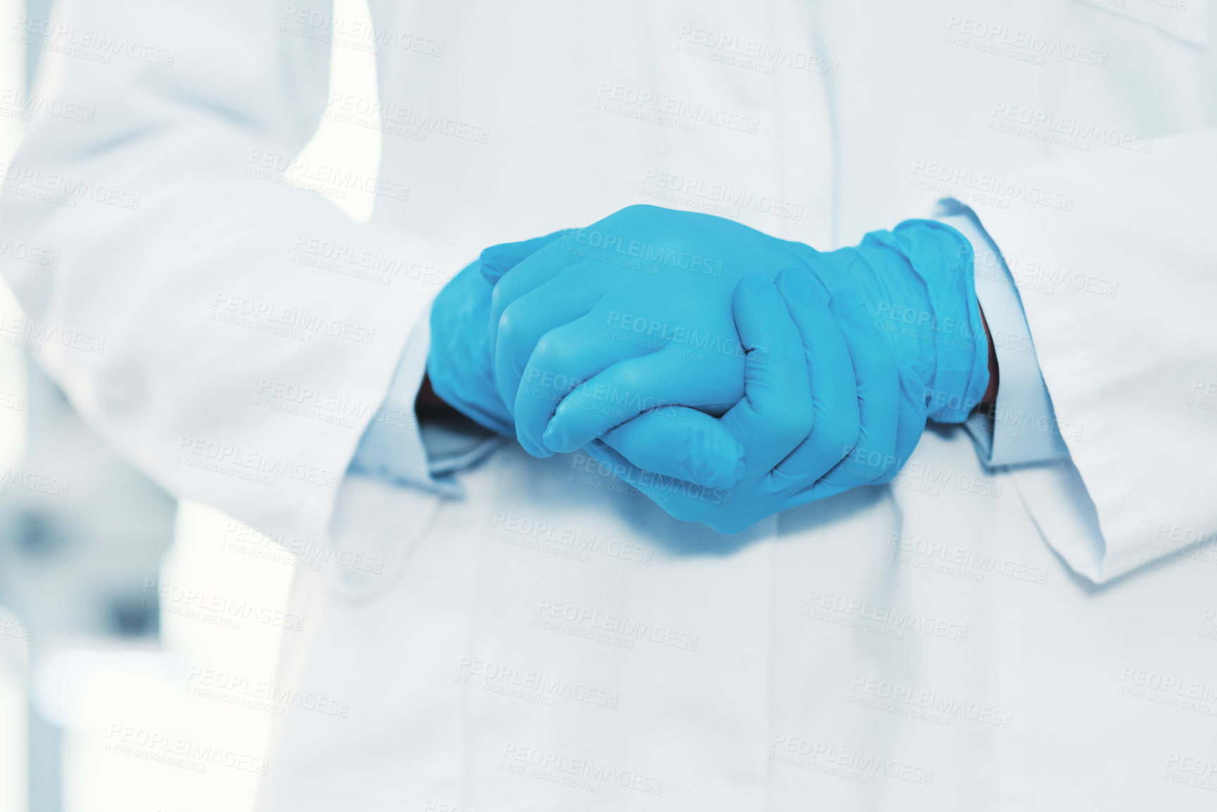 Buy stock photo Cropped shot of an unrecognizable scientist wearing gloves while holding her hands together inside of a laboratory