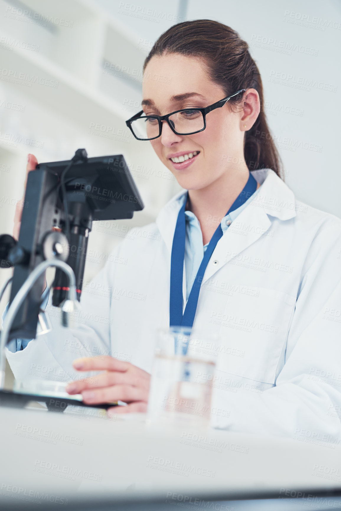 Buy stock photo Microscope, sample and scientist with clinical research, chemistry lab and biology for pharmaceutical. Female person, pipette and petri dish for pathology, test and results in mpox vaccine in Denmark