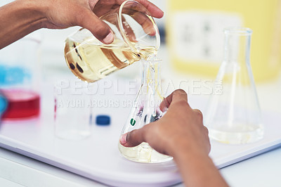 Buy stock photo Closeup of an unrecognizable female scientist mixing chemicals together inside of a laboratory