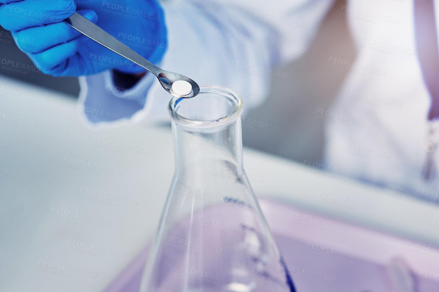 Buy stock photo Closeup of an unrecognizable scientist adding a compound into a test tube inside of a laboratory during the day