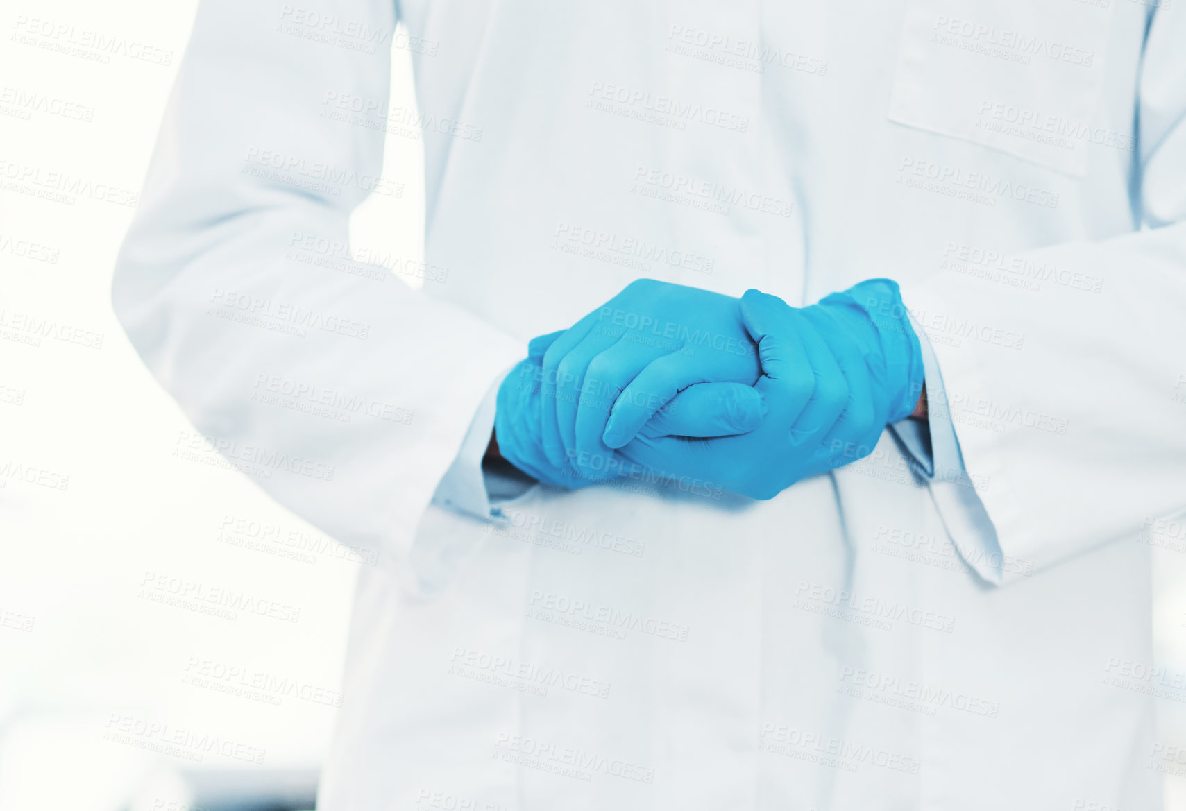 Buy stock photo Cropped shot of an unrecognizable scientist wearing gloves while holding her hands together inside of a laboratory
