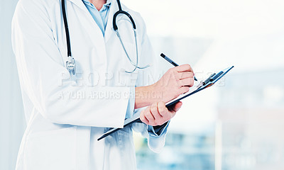 Buy stock photo Cropped shot of an unrecognizable doctor making notes on a clipboard inside of a hospital
