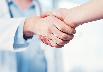 Buy stock photo Closeup of an unrecognizable doctor shaking hands with a patient inside of a hospital during the day