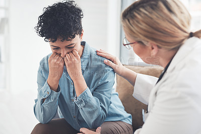 Buy stock photo Cropped shot of a compassionate young female doctor consoling a female patient in her office
