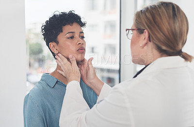 Buy stock photo Cropped shot of an attractive young female doctor examining a female patient in her office