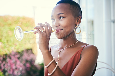 Buy stock photo Cropped shot of a young woman drinking a glass of champagne outside