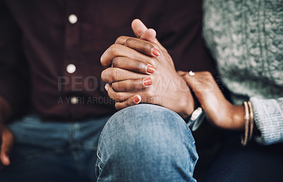 Buy stock photo Cropped shot of an unrecognizable couple holding hands together at home