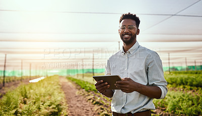 Buy stock photo Young African male farmer working on healthy agriculture development strategy on his digital tablet. Smiling field worker outdoors on organic farming and growth sustainability check up