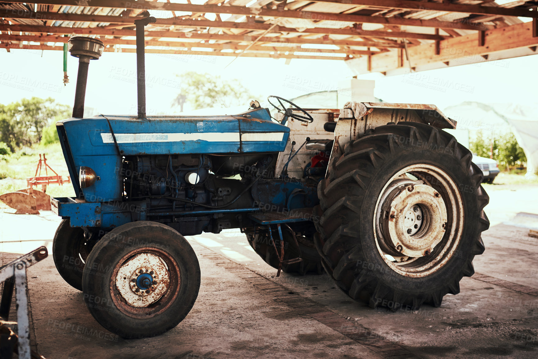 Buy stock photo Still life shot of a tractor parked at a farm