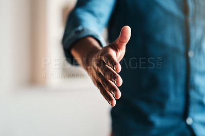 Buy stock photo Cropped shot of an unrecognizable businessman standing alone in his home office and extending his hand for a handshake
