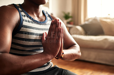 Buy stock photo Shot of a young man practising yoga at home during the day