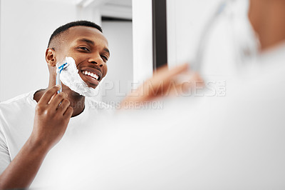 Buy stock photo Cropped shot of a man shaving his beard in the bathroom at home