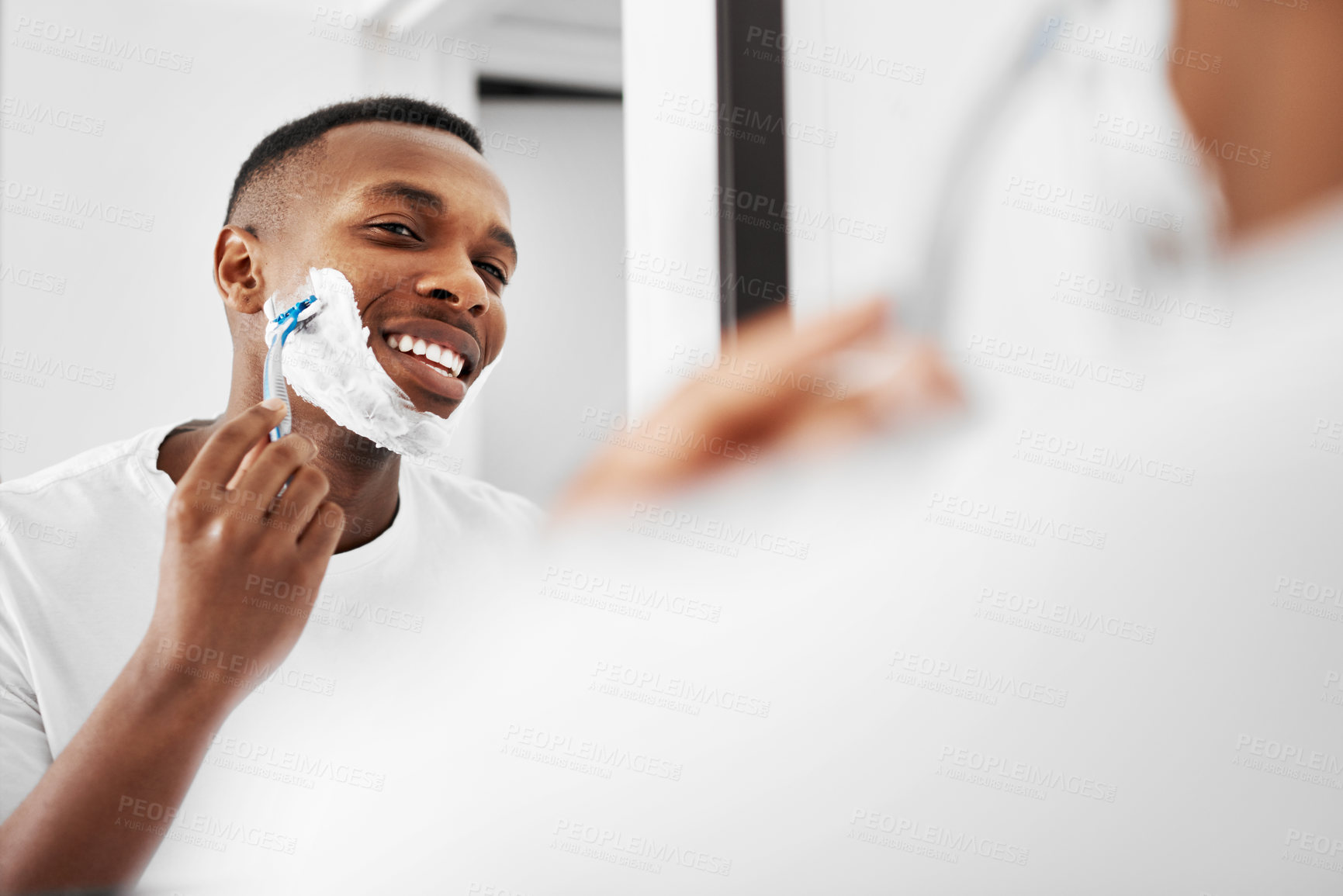 Buy stock photo Cropped shot of a man shaving his beard in the bathroom at home