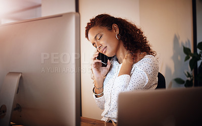Buy stock photo Shot of a young businesswoman holding her neck in pain while working in an office at night