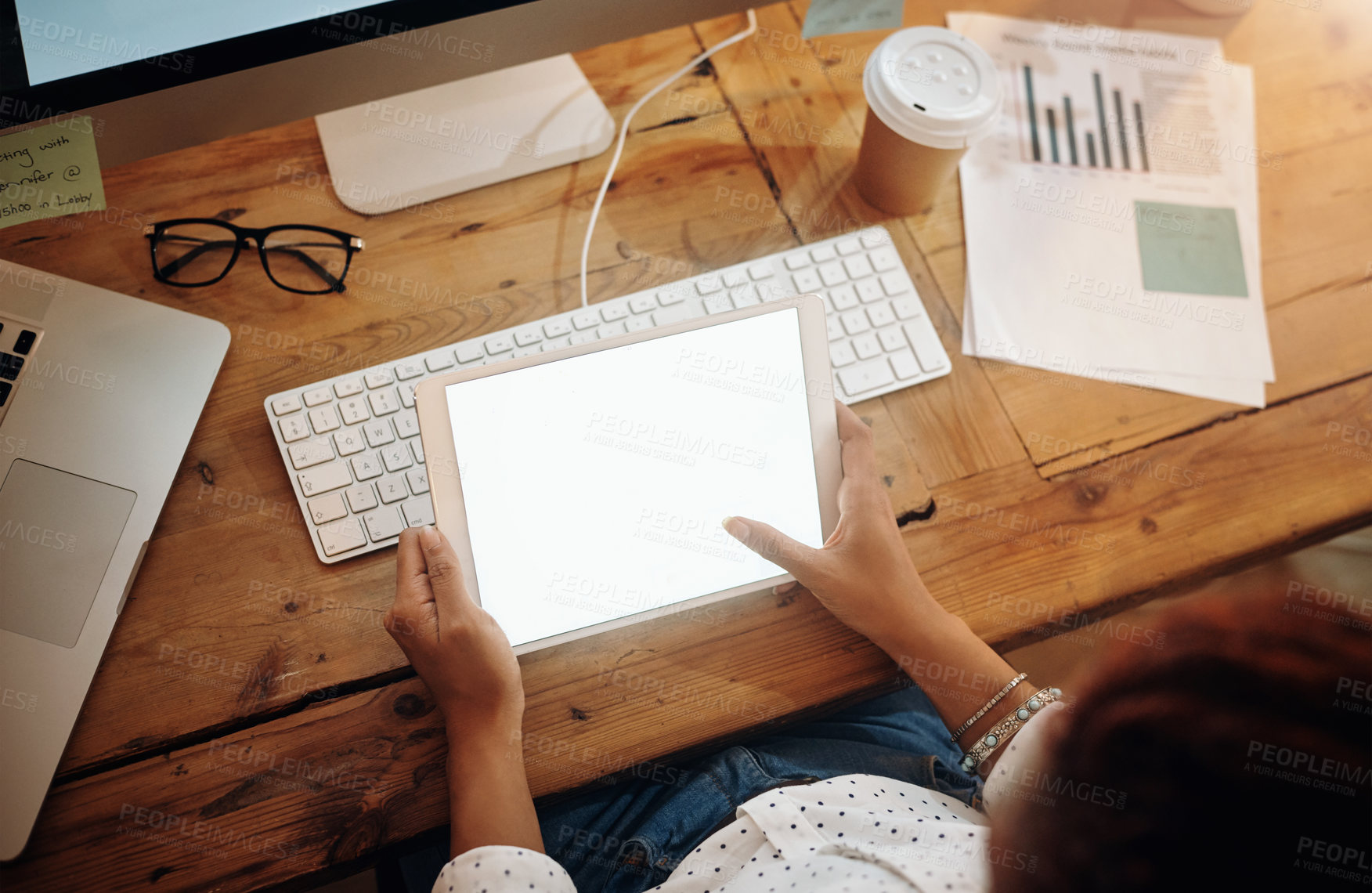 Buy stock photo High angle shot of an unrecognisable businesswoman using a digital tablet in an office at night