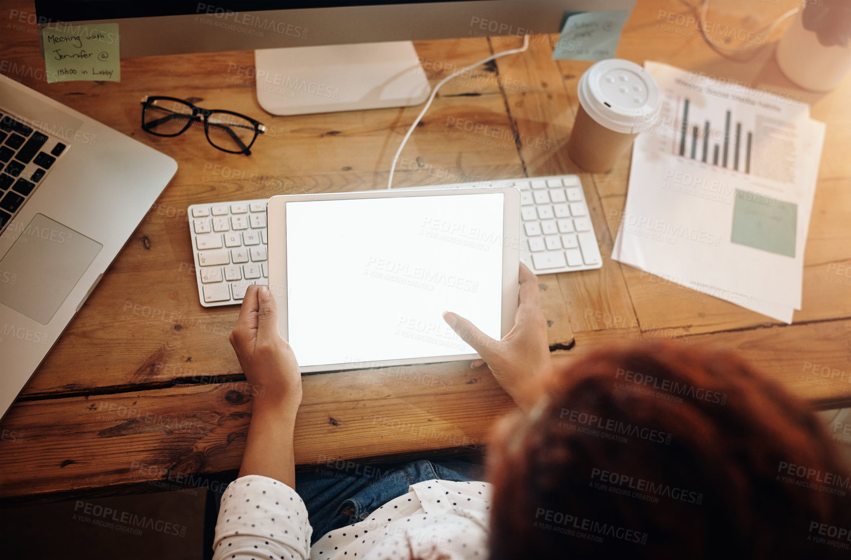 Buy stock photo High angle shot of an unrecognisable businesswoman using a digital tablet in an office at night