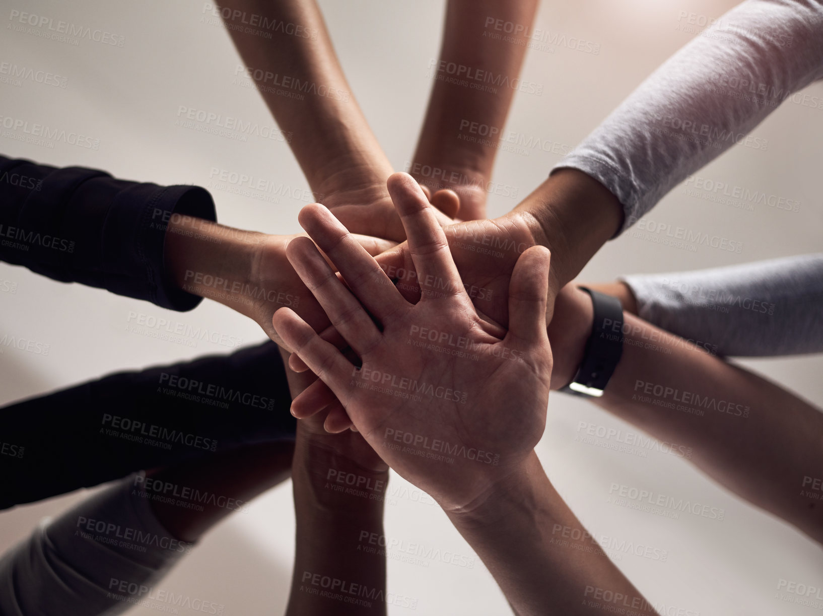 Buy stock photo Cropped shot of a group of people joining their hands together in solidarity at a gym