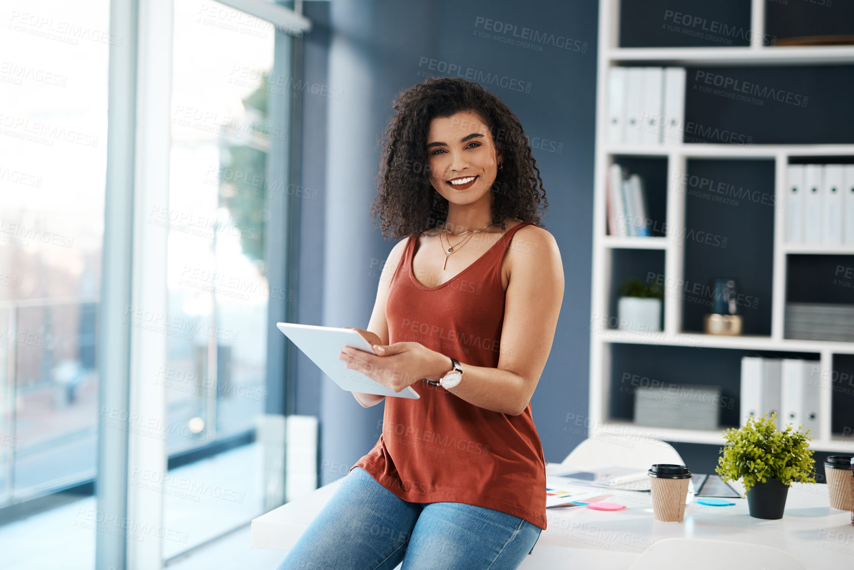 Buy stock photo Cropped portrait of an attractive young businesswoman sitting alone in her office and using a tablet