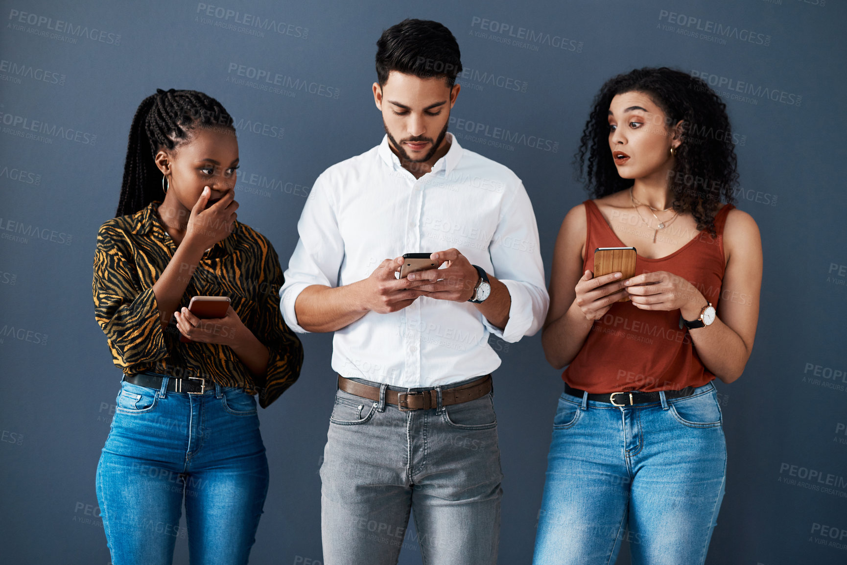 Buy stock photo Business, people and surprise with phone for job interview or results on a studio background in line. Diversity, mobile and shocked candidates for career internship, human resources and onboarding