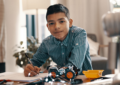 Buy stock photo Learning, writing and portrait of kid with robotics homework, homeschool and science for tech project. Taking notes, car robot and boy child with knowledge, education and studying in house alone.