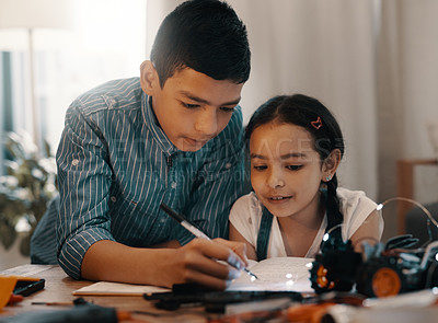 Buy stock photo Shot of two adorable young siblings doing robotics homework together at home
