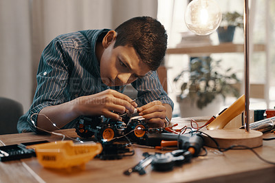 Buy stock photo Education, car robot and kid in home with homework, homeschool and science, learning and tech project. Robotics, building and boy child with electrical knowledge, engineering and studying in house.