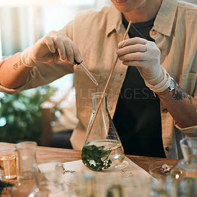 Buy stock photo Cropped shot of an unrecognizable botanist adding a liquid nutrient to a water based plant inside a glass jar