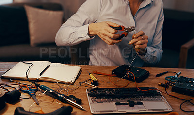 Buy stock photo Cropped shot of an unrecognizable female computer technician repairing a hard drive in her workshop