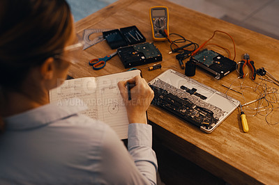 Buy stock photo Rearview shot of a young female computer technician repairing a laptop in her workshop