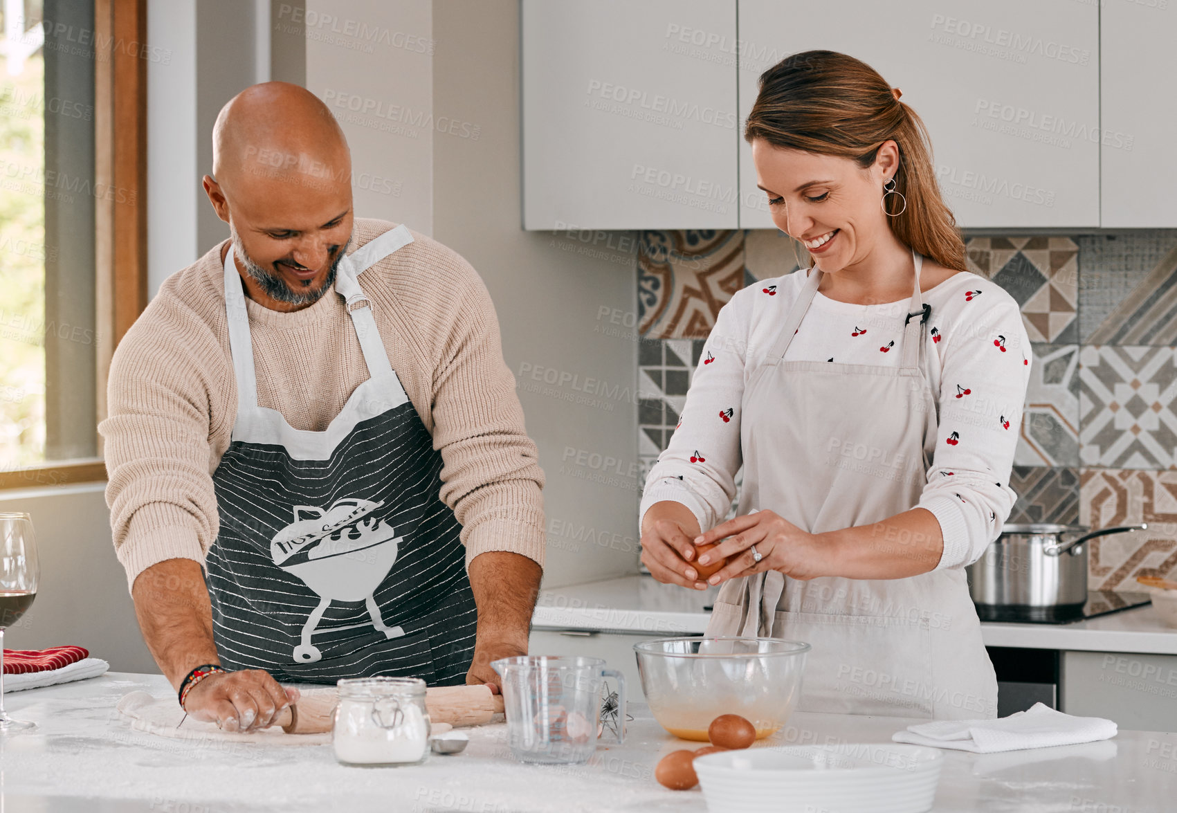 Buy stock photo Shot of a happy mature couple baking together at home