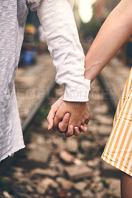 Buy stock photo Cropped shot of a couple holding hands in the city of Vietnam