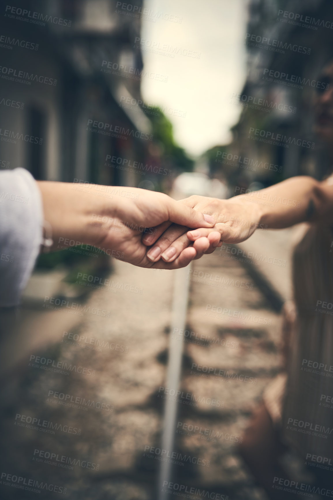 Buy stock photo Holding hands, couple and outdoor on train track in city, travel and connection for love on vacation. People, railway and bonding in metro town with care, loyalty or trust for relationship in Vietnam