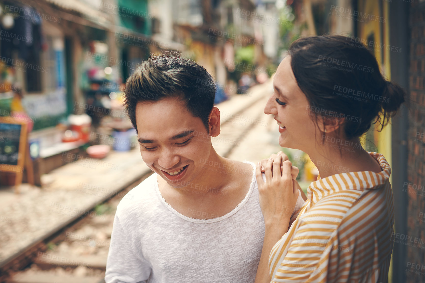 Buy stock photo Travel, hug and couple at train tracks for holiday, relax and outdoor bonding together on romantic date. Love, man and woman embrace on walk with care, weekend adventure and happy vacation in Vietnam