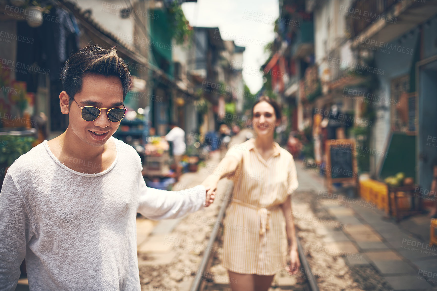 Buy stock photo Holding hands, walking and couple in city for travel on holiday, vacation and honeymoon together. Happy, tourist destination and man and woman in street for adventure, journey and explore in Vietnam