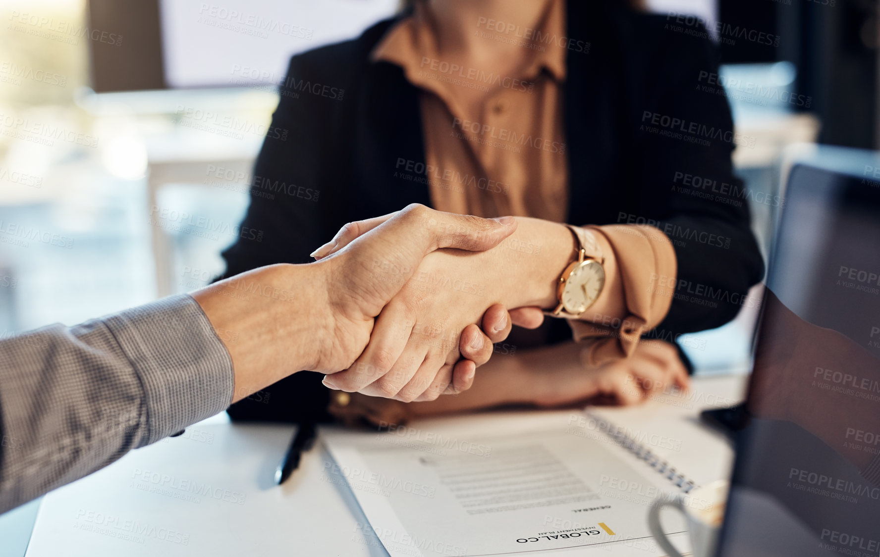 Buy stock photo Cropped shot of a businesswoman and businessman shaking hands during a meeting in a modern office
