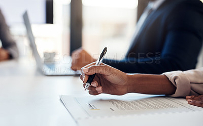 Buy stock photo Cropped shot of a businesswoman going through paperwork during a meeting in the boardroom of a modern office