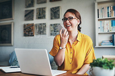 Buy stock photo Cropped shot of an attractive young businesswoman sitting alone in her home office and talking on her cellphone
