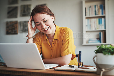 Buy stock photo Cropped shot of an attractive young businesswoman sitting alone in her office and feeling overwhelmed while using her laptop