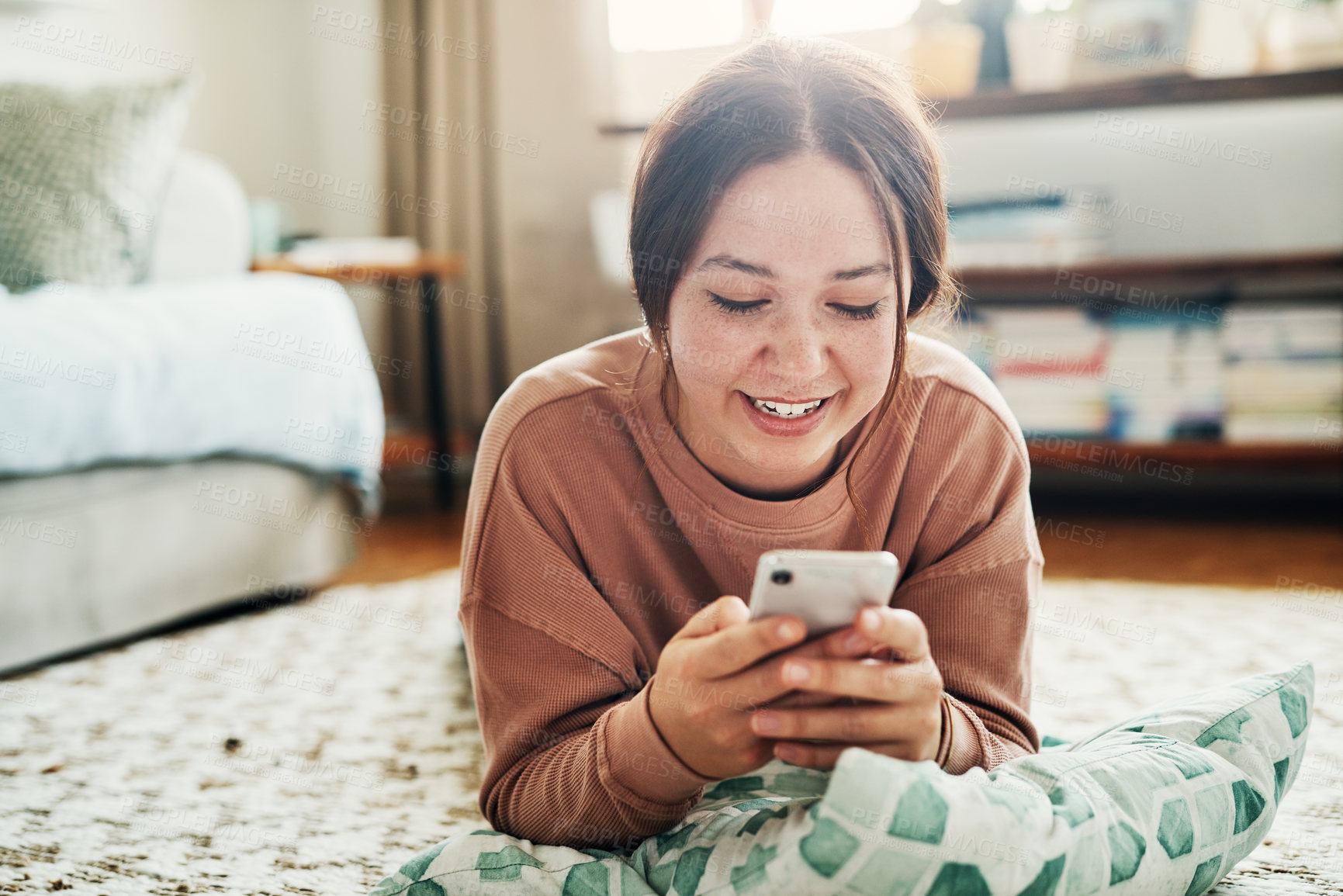 Buy stock photo Woman, smartphone and lying on floor with communication, typing or social media scroll in home living room. Girl, smile and cellphone on carpet for chat, texting or technology with internet in lounge